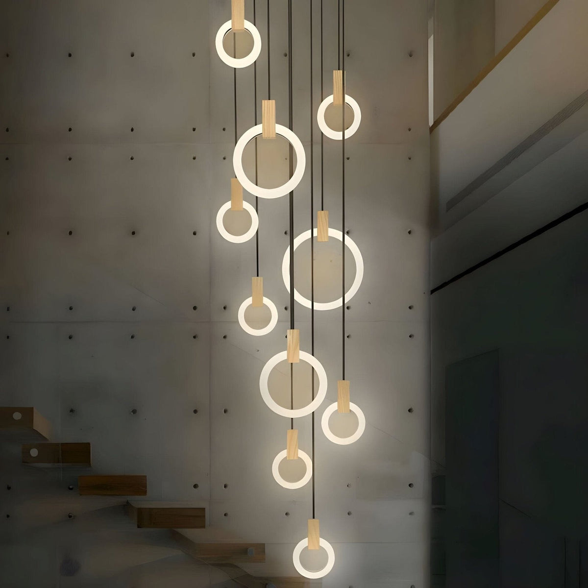 Ylva ring chandelier beside a concrete staircase