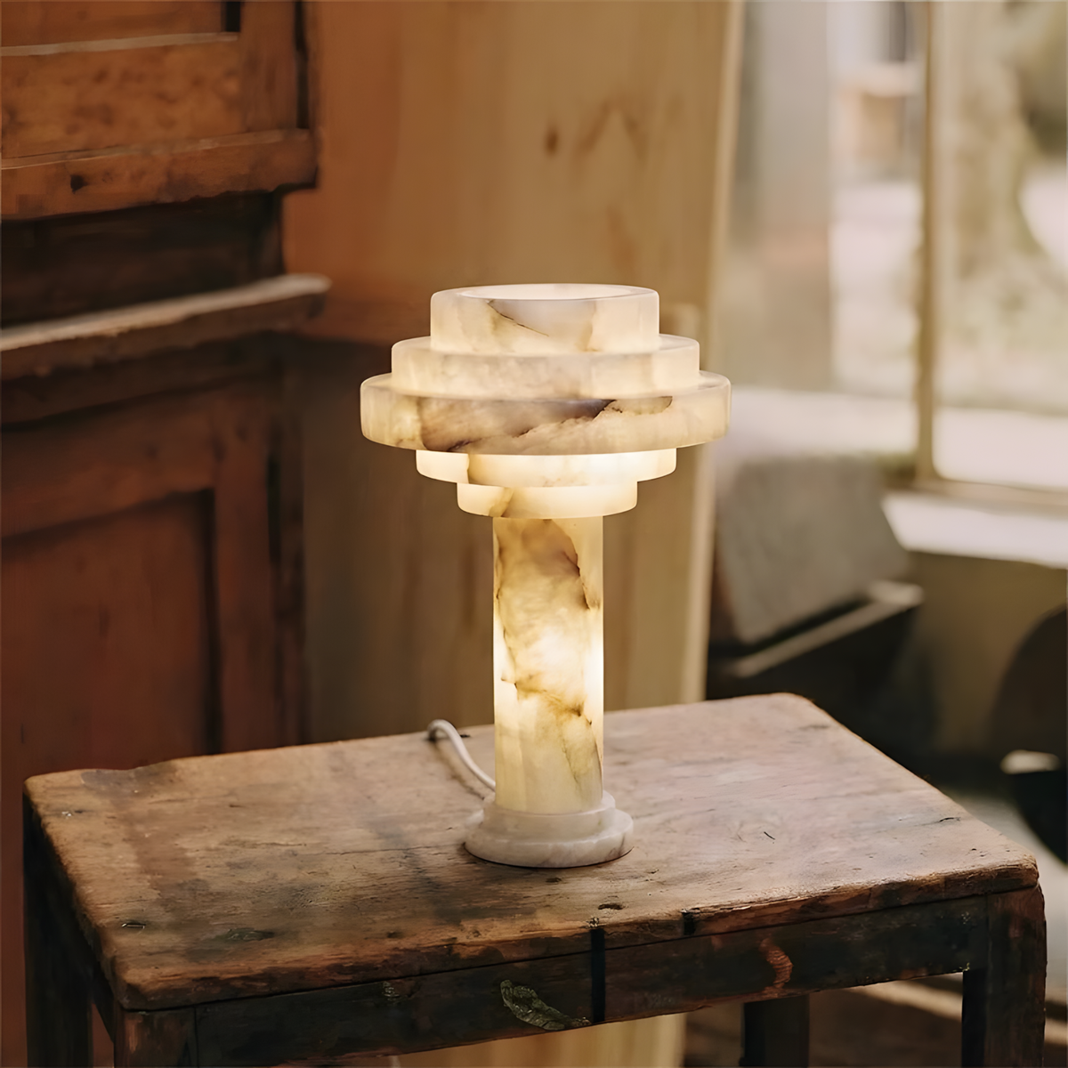 Edda Japandi Alabaster Table Lamp lit on a side table