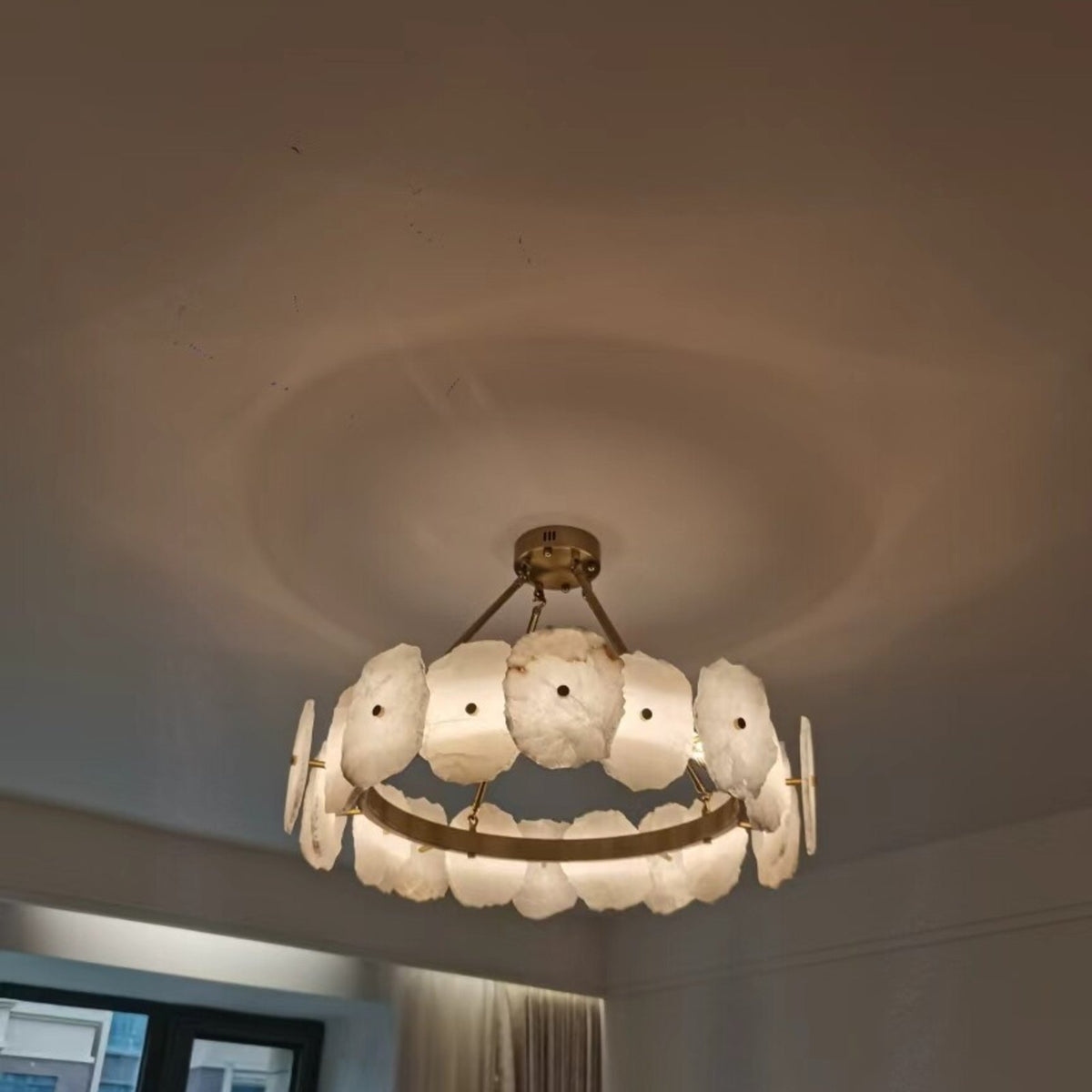 Customer photo of the Isola round alabaster chandelier lit