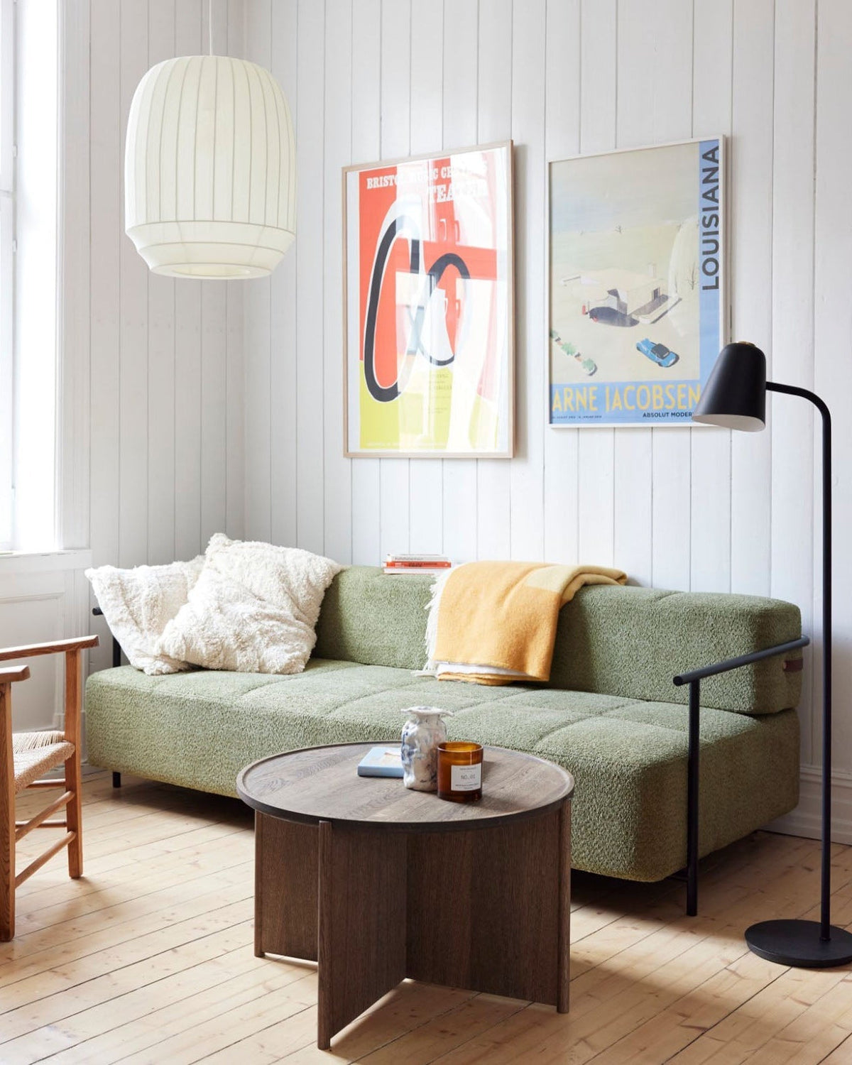 Wren pendant in a living room with a sage sofa