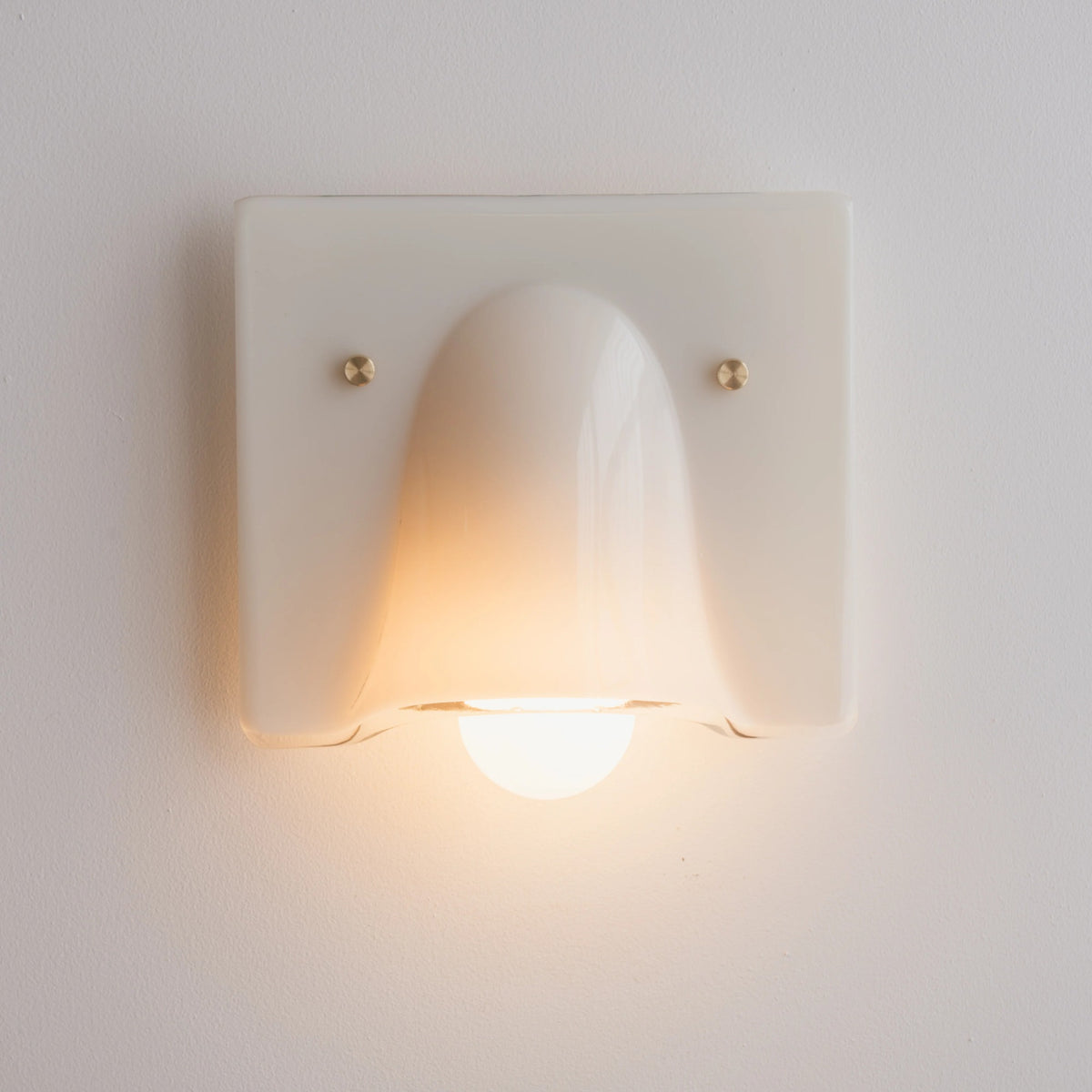Linnea cream single head wall light glowing warm