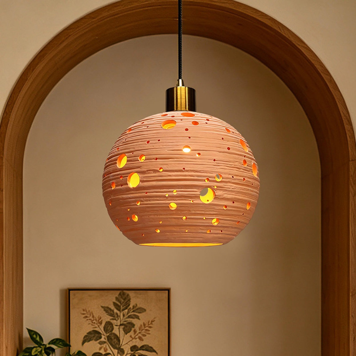 Brasa terracotta globe pendant in an arched alcove