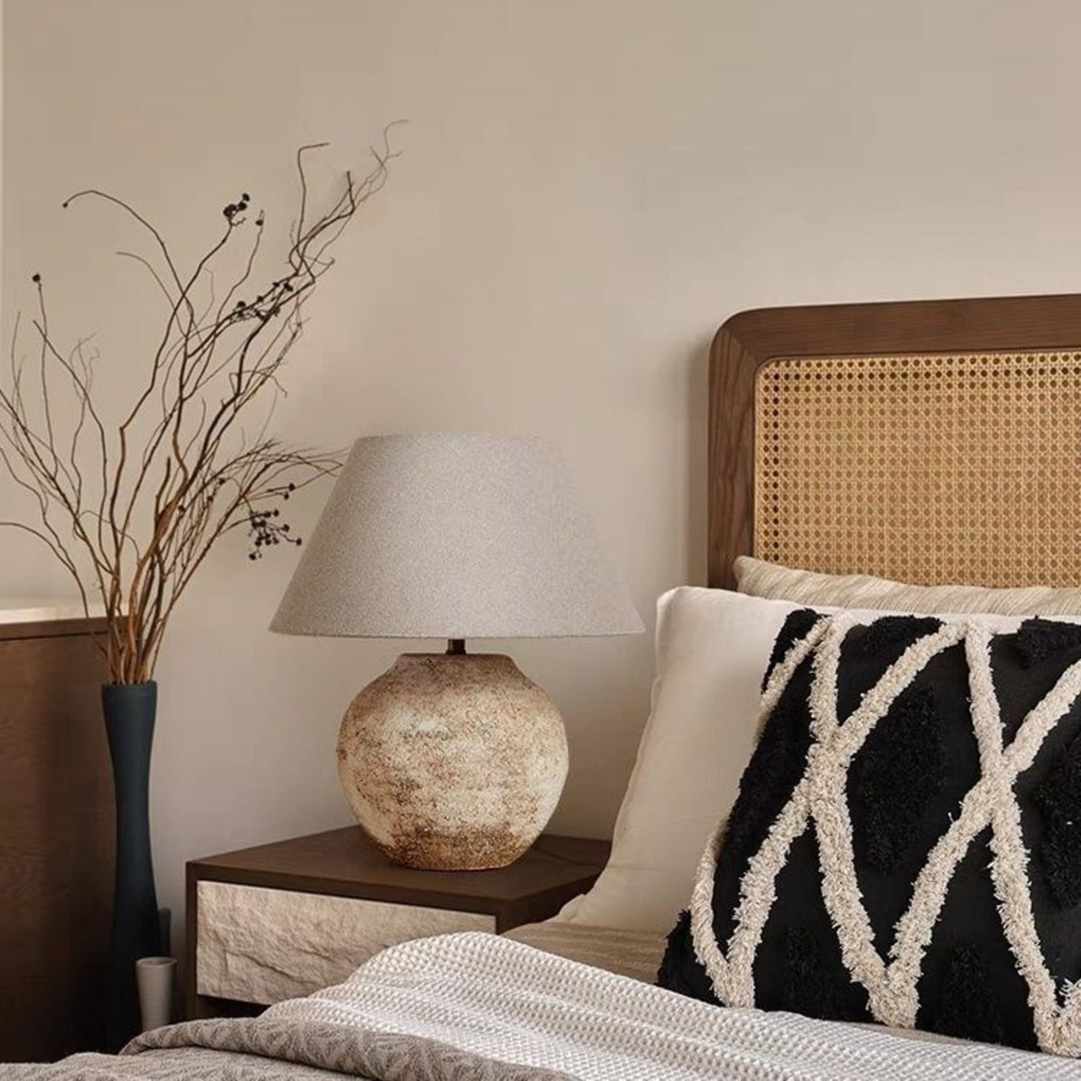 Tsumugi table lamp in a Japandi bedroom with rattan headboard