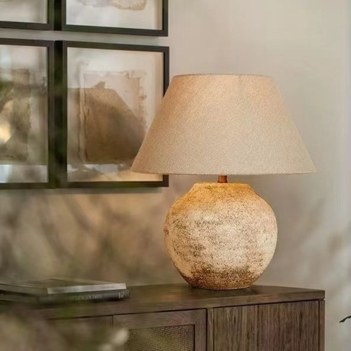 Tsumugi wabi sabi lamp on a dark wood shelf by a window