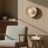 Himawari cream ceramic sunflower wall light above an oak side table beside an armchair