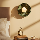 Himawari Indian green ceramic wall light above a bedside table in warm sunlight