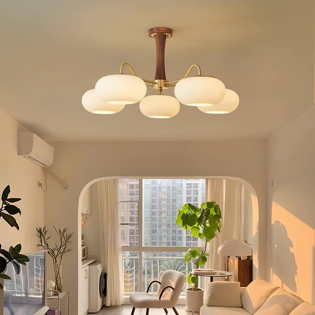 Kaki chandelier glowing warm in an arched living room
