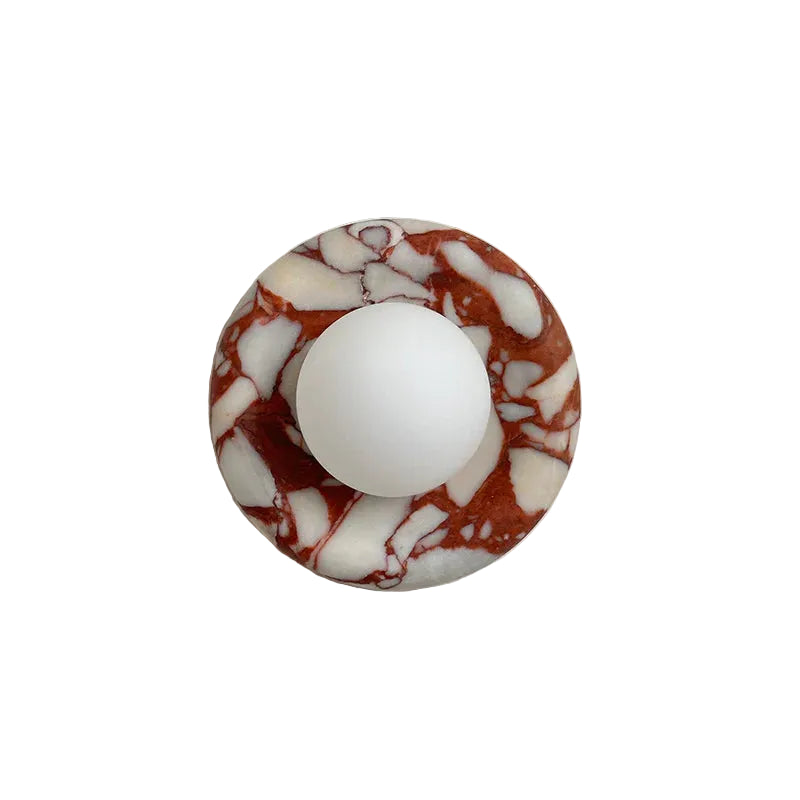 Marble-patterned circular object with a white center on a light gray background