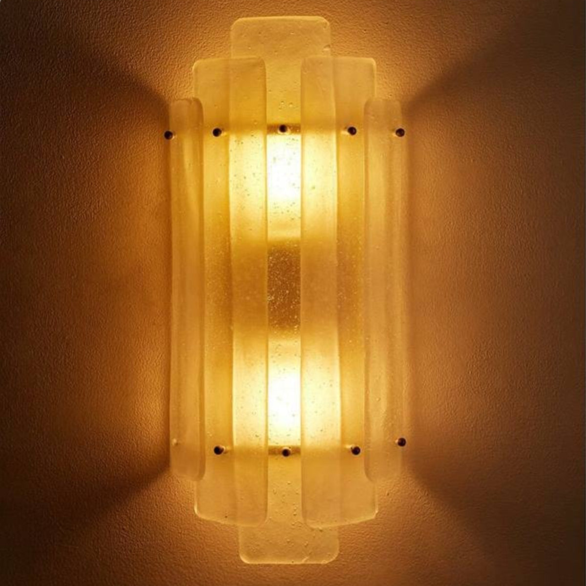 Freya Nordic Glass Wall Light glowing at night