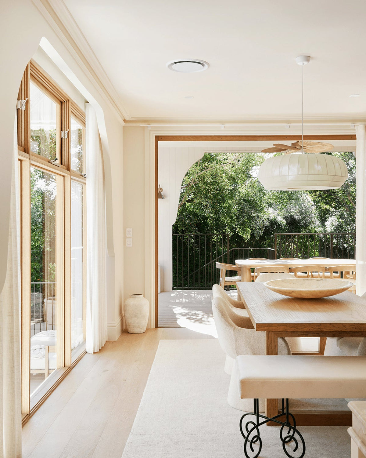 Wren pendant over a garden-view dining table