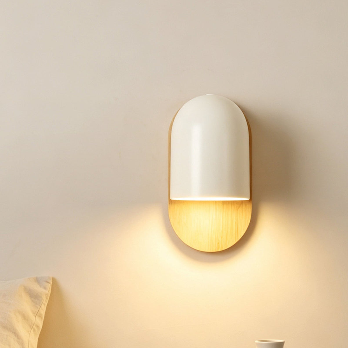 Kodama wall light glowing beside a bed