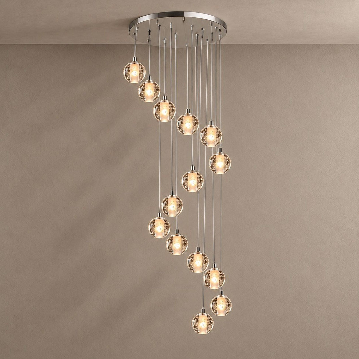 Nimbus spiral bubble glass chandelier against a plaster wall