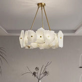Isola alabaster chandelier above a vase of branches