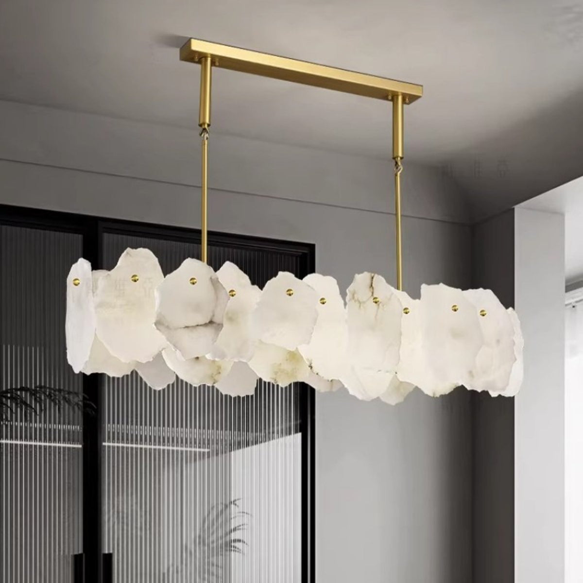 Isola linear alabaster chandelier by a window