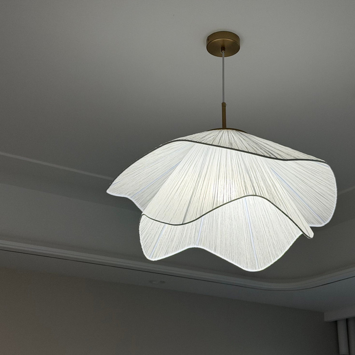 Radiance of Serenity wavy fabric pendant light installed on a ceiling