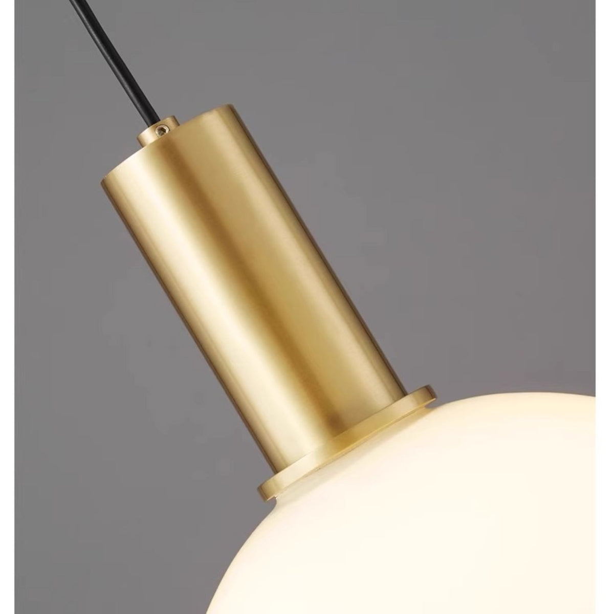 Close-up of Selma brushed brass cap and opal glass