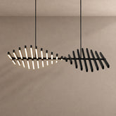 Talia twisted LED pendant glowing against a plaster wall