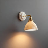 Suzu fluted bell wall light switched on