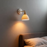 Suzu wall light beside a bed