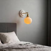 Suzu ribbed globe above a headboard