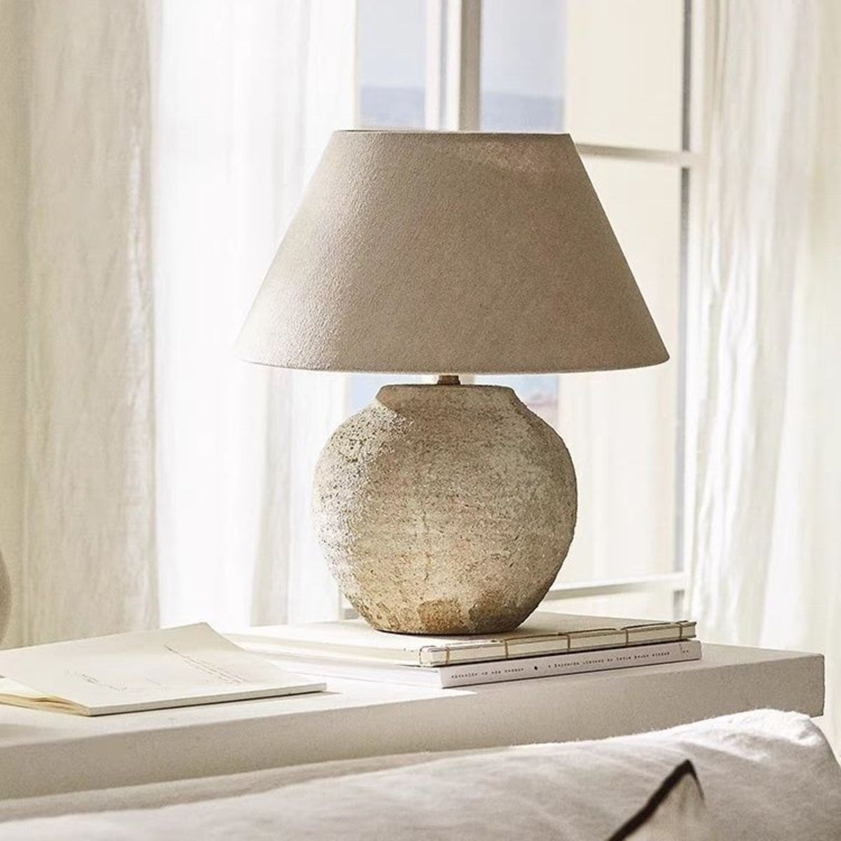 Tsumugi wabi sabi ceramic table lamp beside a sunlit window