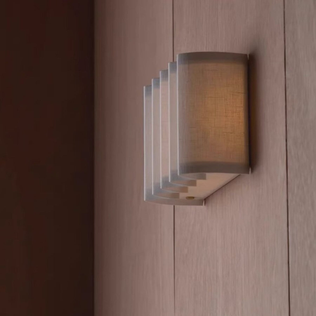 Side view of the Wave pleated linen wall lamp