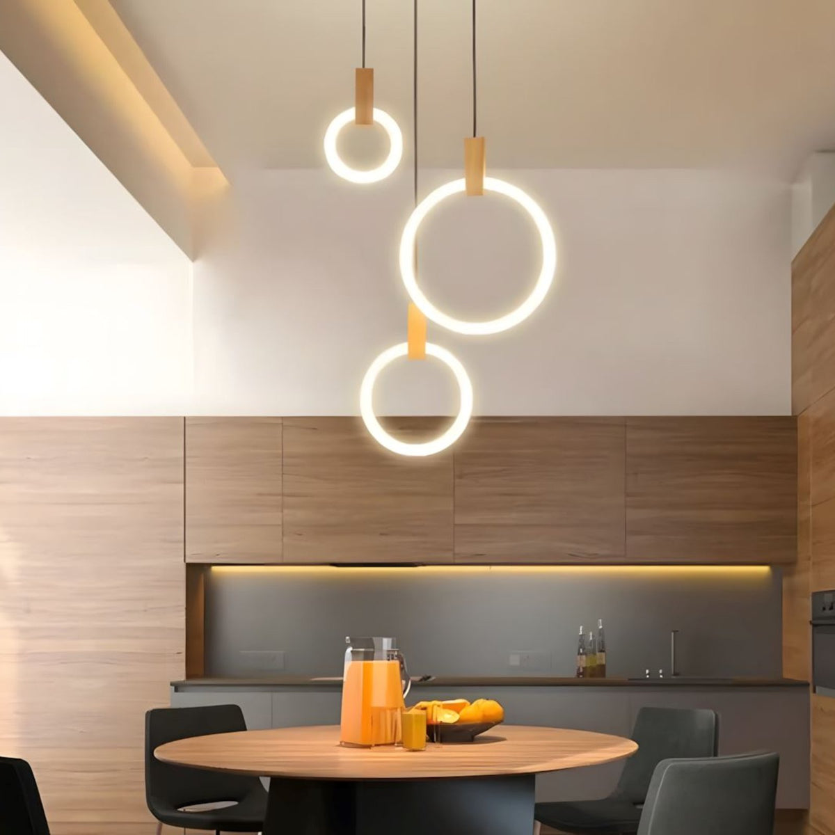 Three Ylva single rings above a round dining table