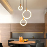 Three Ylva single rings above a round dining table