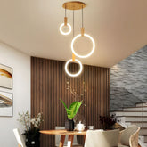 Ylva three ring pendant above a dining table by the stairs