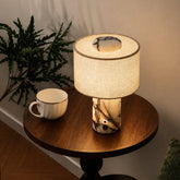 Yoru lamp glowing on a round side table