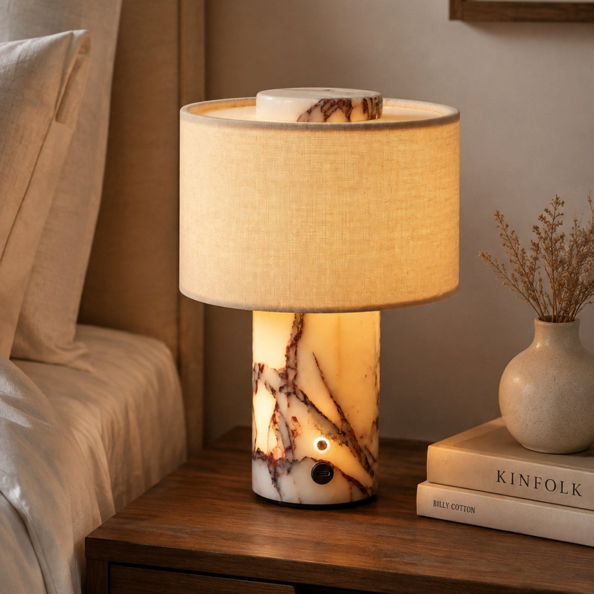 Yoru glowing marble lamp on a bedside table